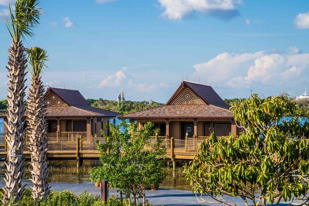 Disney Vacation Club Polynesian Village Resort villas behind trees, on the water