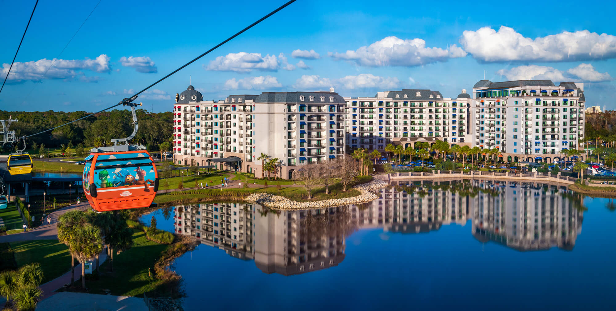 Riviera dvc resort hotel at Disney World, surrounded by palm trees and clear blue skies